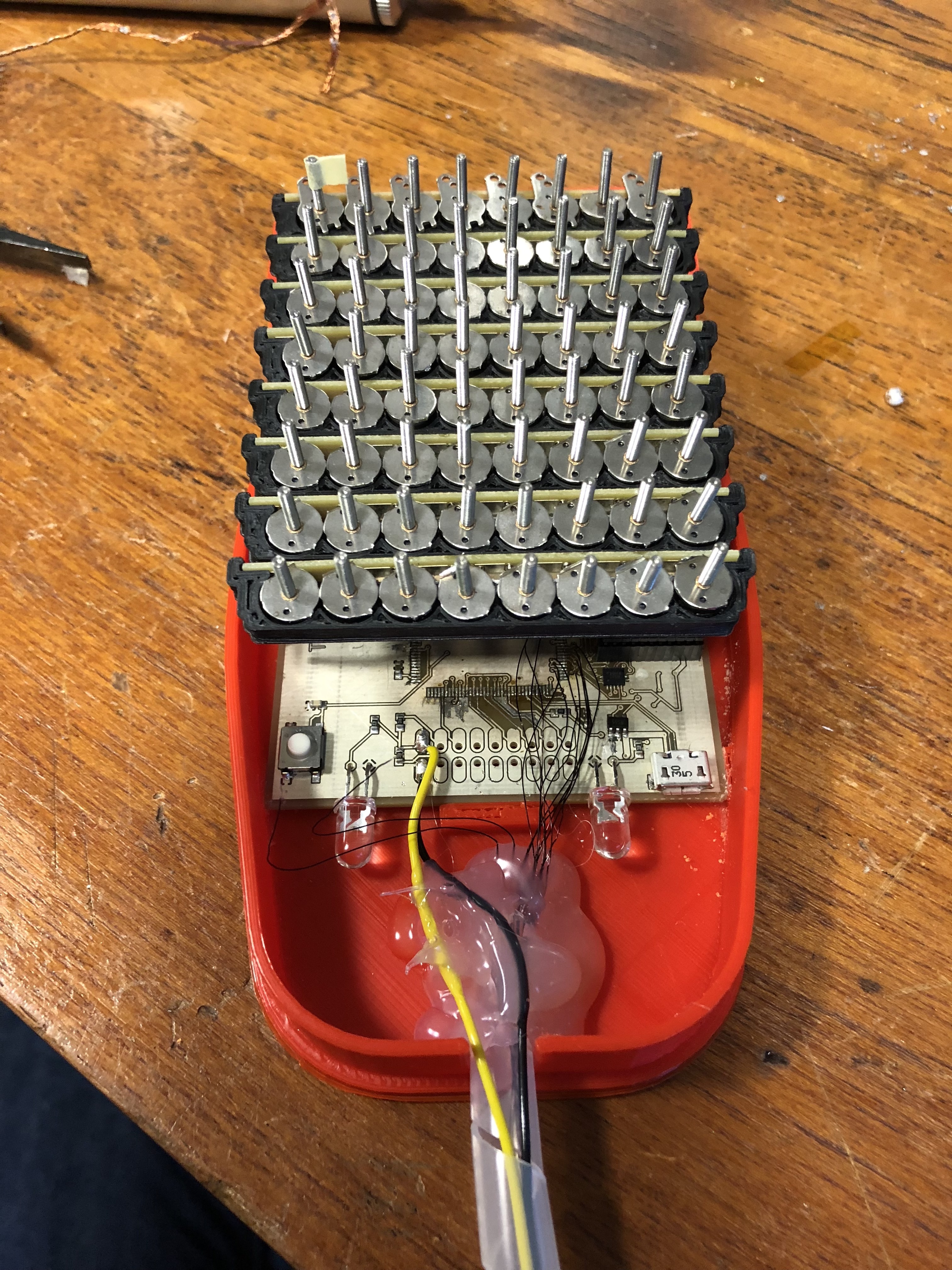 64 stepper motors assembled to drive an 8x8 taxel tactile display